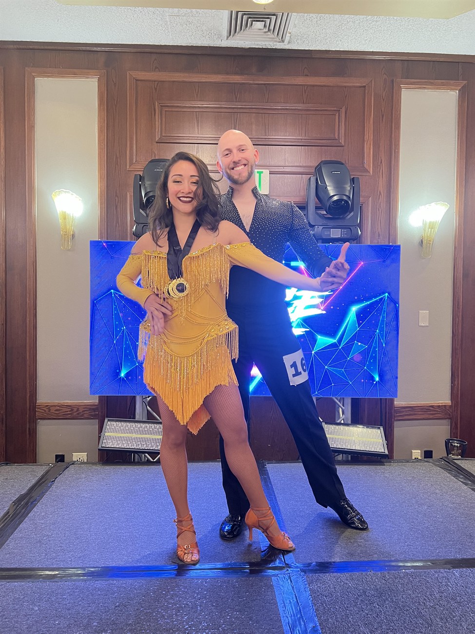 Award-winning dance couple in gold costume