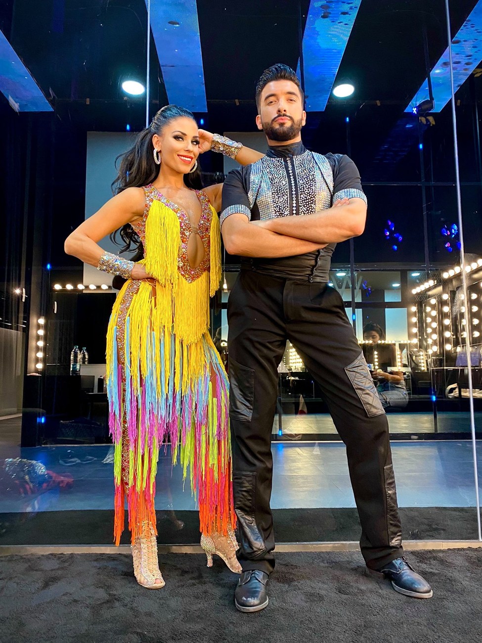 Dance couple wearing bright competition costumes