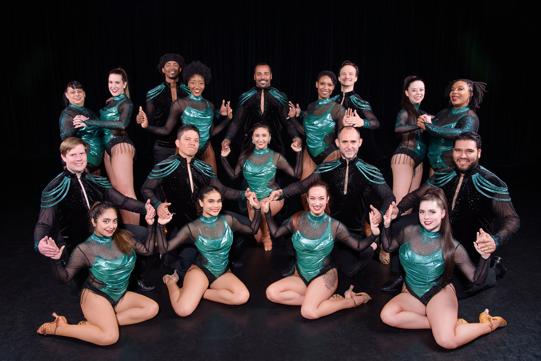 Large dance team in green and black costumes